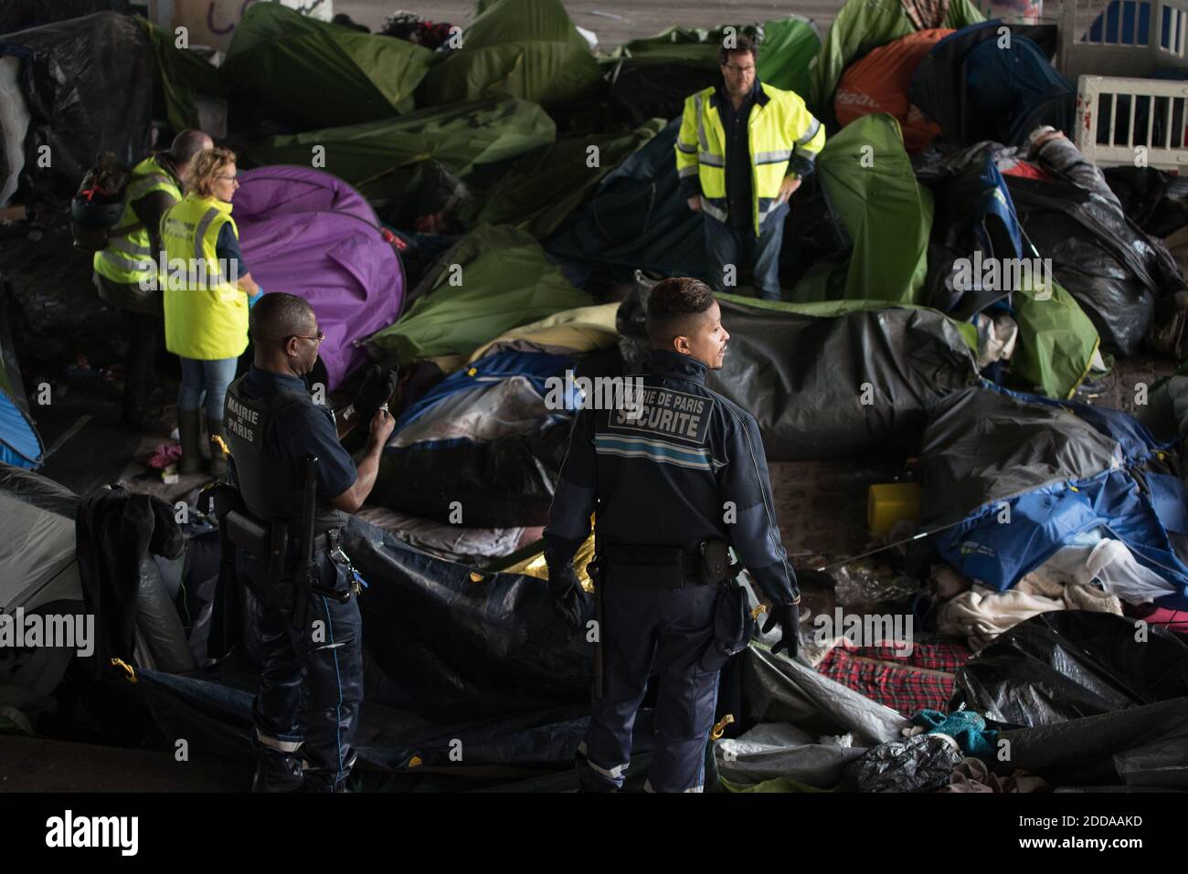 Workers clean up the Millenaire migrants makeshift camp along the Canal de Saint-Denis near Porte de la Villette, northern Paris, France, following its evacuation on May 30, 2018. More than a thousand migrants and refugees were evacuated on early May 30, 2018 from a makeshift camp that had been set up for several weeks along the Canal. Photo by Samuel Boivin/ABACAPRESS.COM Stock Photo