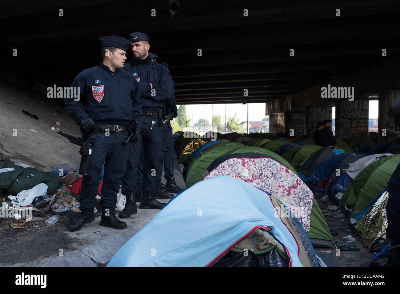 A police officer stands guard at the Millenaire migrants makeshift camp along the Canal de Saint-Denis near Porte de la Villette, northern Paris, France, following its evacuation on May 30, 2018. More than a thousand migrants and refugees were evacuated on early May 30, 2018 from a makeshift camp that had been set up for several weeks along the Canal. Photo by Samuel Boivin/ABACAPRESS.COM Stock Photo