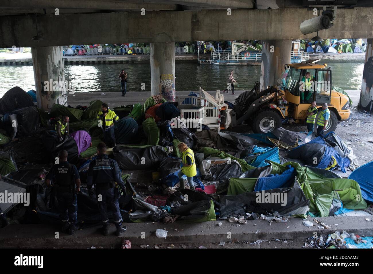Workers clean up the Millenaire migrants makeshift camp along the Canal de Saint-Denis near Porte de la Villette, northern Paris, France, following its evacuation on May 30, 2018. More than a thousand migrants and refugees were evacuated on early May 30, 2018 from a makeshift camp that had been set up for several weeks along the Canal. Photo by Samuel Boivin/ABACAPRESS.COM Stock Photo
