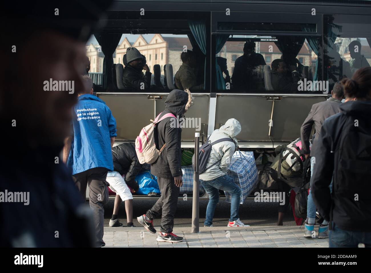 Migrants and refugees load their belongings in a bus during the evacuation of the Millenaire makeshift camp along the Canal de Saint-Denis near Porte de la Villette, northern Paris, France, on May 30, 2018. More than a thousand migrants and refugees were evacuated on early May 30, 2018 from a makeshift camp that had been set up for several weeks along the Canal. Photo by Samuel Boivin/ABACAPRESS.COM Stock Photo