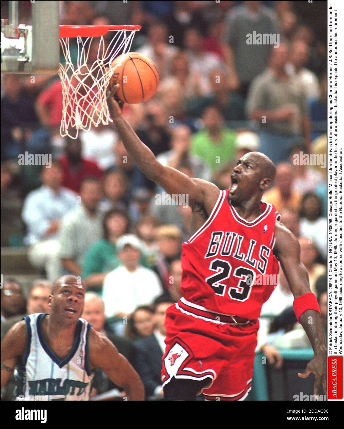 NO FILM, NO VIDEO, NO TV, NO DOCUMENTARY - © Patrick Schneider/KRT/ABACA. 28924-1. Charlotte-NC-USA. 10/05/98. Chicago Bulls' Michael Jordan drives to the hoop during as Charlotte Hornets' J.R. Reid looks on from under the basket in during their playoff game on May 10, 1998. Jordan, regarded as th Stock Photo