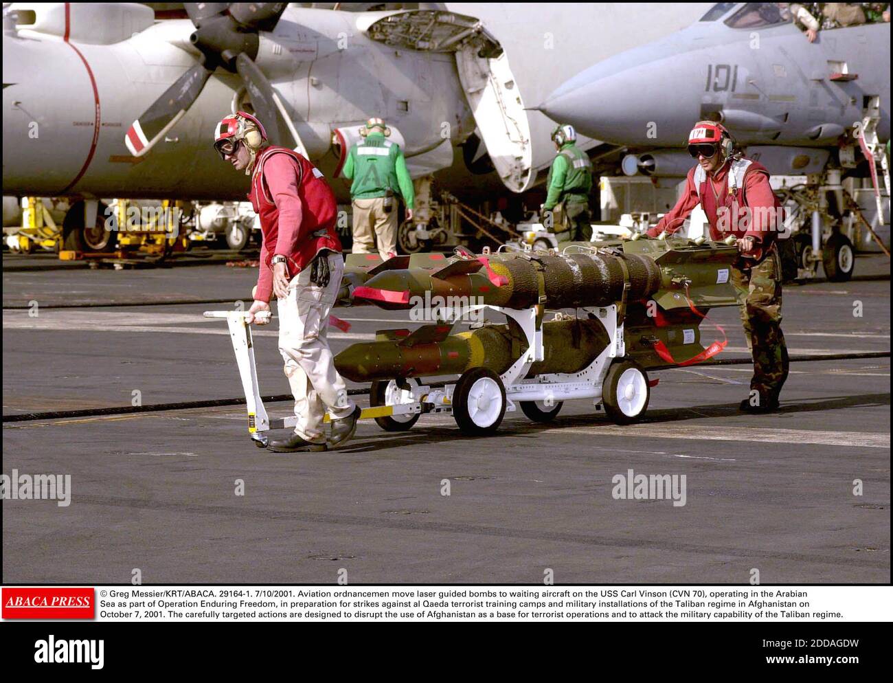 NO FILM, NO VIDEO, NO TV, NO DOCUMENTARY - © Greg Messier/KRT/ABACA. 29164-1. 7/10/2001. Aviation ordnancemen move laser guided bombs to waiting aircraft on the USS Carl Vinson (CVN 70), operating in the Arabian Sea as part of Operation Enduring Freedom, in preparation for strikes against al Qaeda Stock Photo
