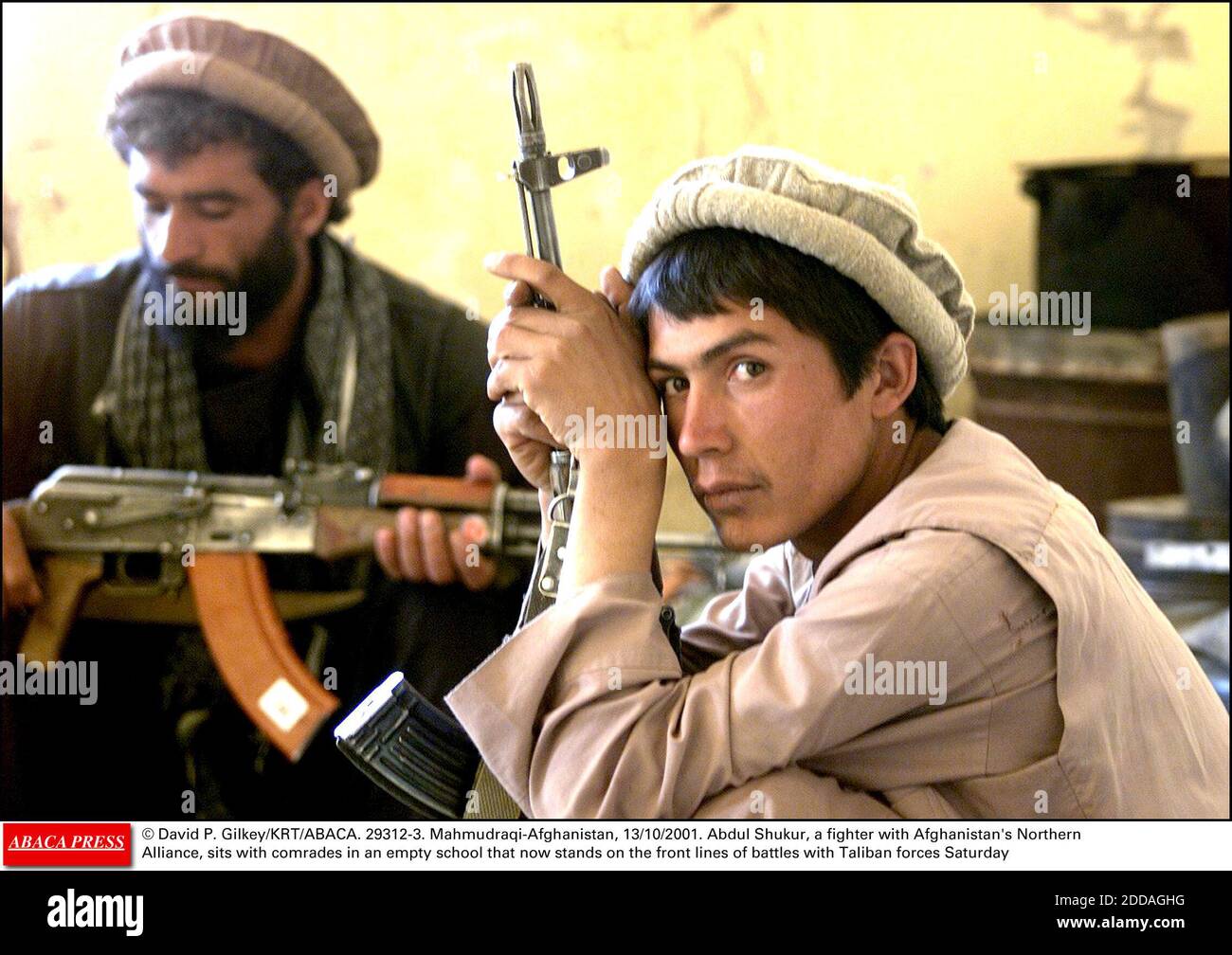 NO FILM, NO VIDEO, NO TV, NO DOCUMENTARY - © David P. Gilkey/KRT/ABACA. 29312-3. Mahmudraqi-Afghanistan, 13/10/2001. Abdul Shukur, a fighter with Afghanistan's Northern Alliance, sits with comrades in an empty school that now stands on the front lines of battles with Taliban forces Saturday Stock Photo