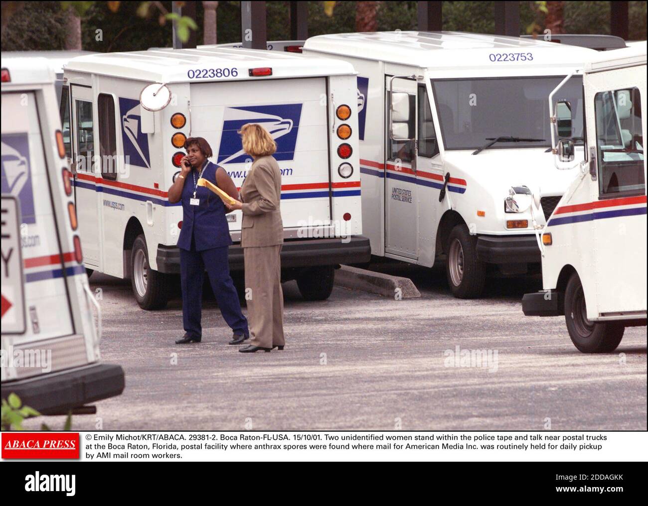 NO FILM, NO VIDEO, NO TV, NO DOCUMENTARY - © Emily Michot/KRT/ABACA. 29381-2. Boca Raton-FL-USA. 15/10/01. Two unidentified women stand within the police tape and talk near postal trucks at the Boca Raton, Florida, postal facility where anthrax spores were found where mail for American Media Inc. Stock Photo
