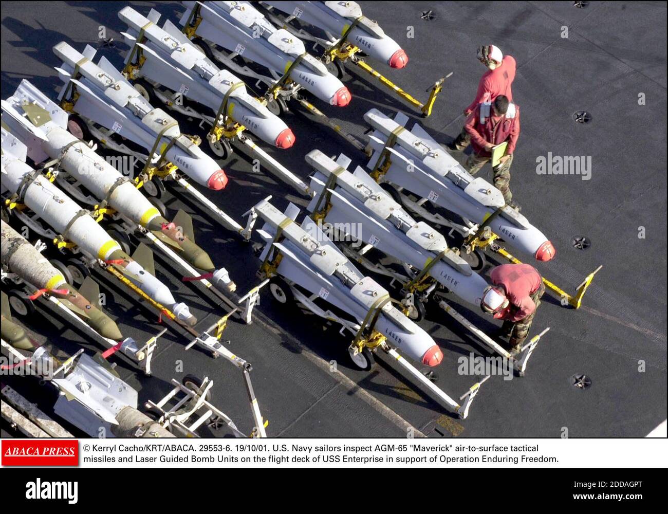 NO FILM, NO VIDEO, NO TV, NO DOCUMENTARY - © Kerryl Cacho/KRT/ABACA. 29553-6. 19/10/01. U.S. Navy sailors inspect AGM-65 Maverick air-to-surface tactical missiles and Laser Guided Bomb Units on the flight deck of USS Enterprise in support of Operation Enduring Freedom. Stock Photo