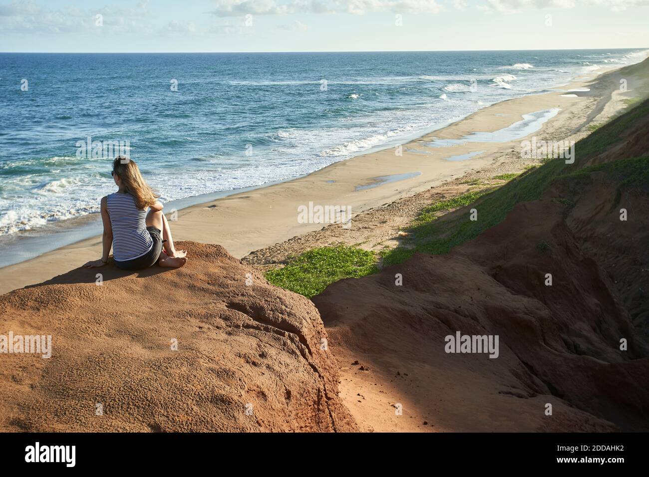 Person sitting on rock formation at hi-res stock photography and images ...