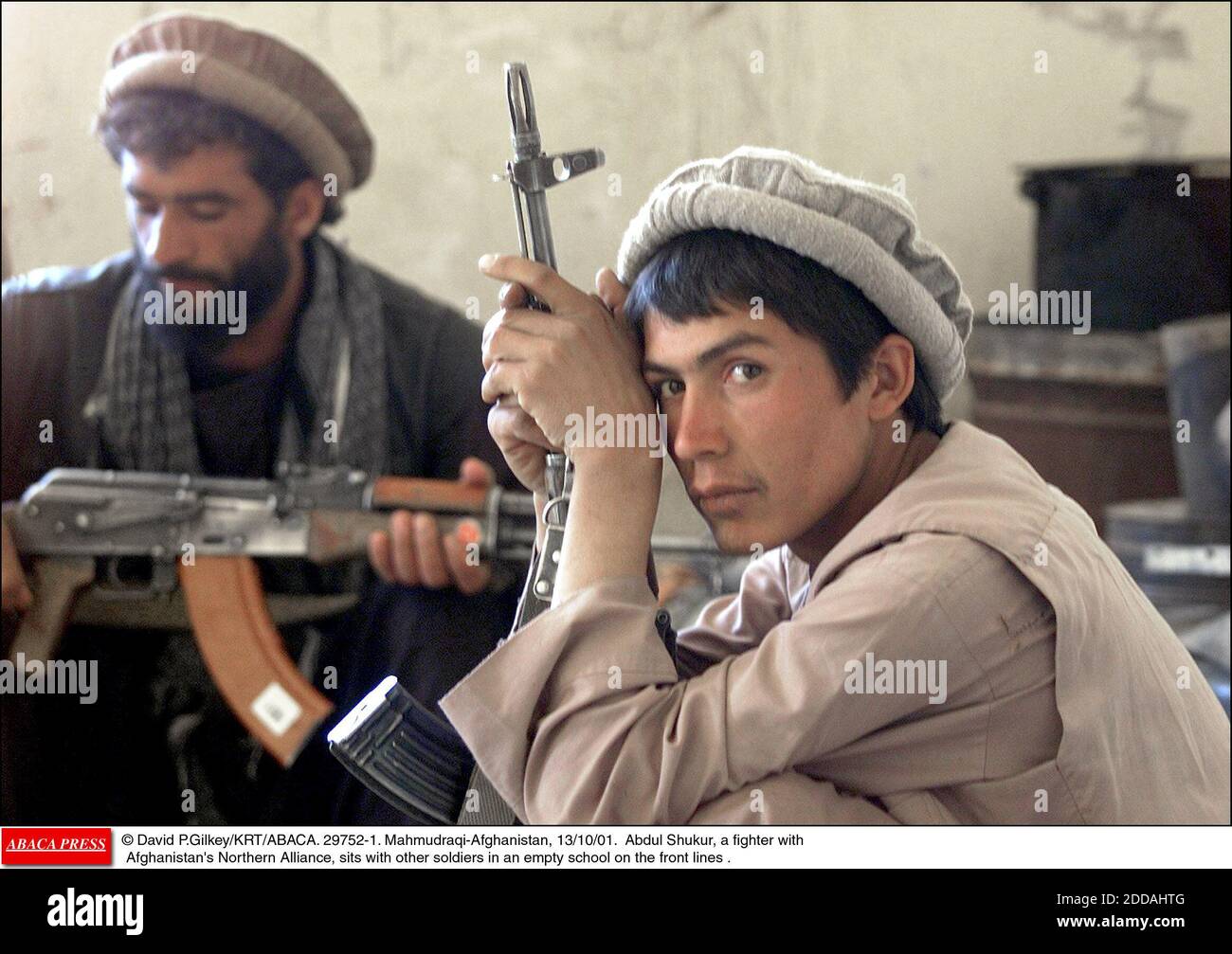 NO FILM, NO VIDEO, NO TV, NO DOCUMENTARY - © David P.Gilkey/KRT/ABACA. 29752-1. Mahmudraqi-Afghanistan, 13/10/01. Abdul Shukur, a fighter with Afghanistan's Northern Alliance, sits with other soldiers in an empty school on the front lines . Stock Photo