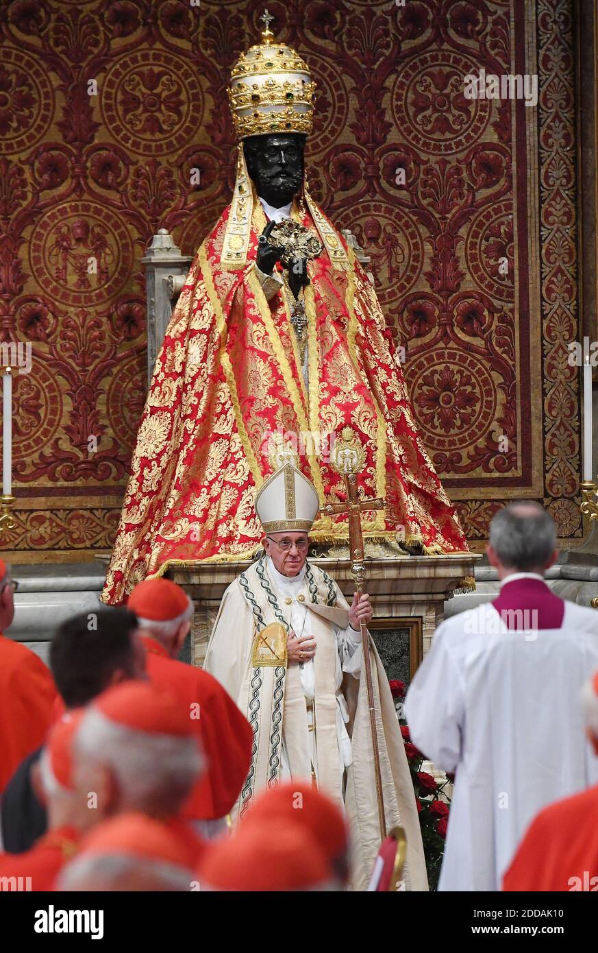 Pope Francis prays in front of the statue of Saint Peter after he