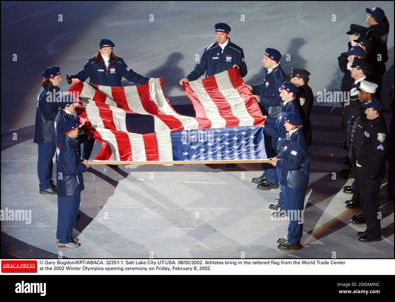 NO FILM, NO VIDEO, NO TV, NO DOCUMENTARY - © Gary Bogdon/KRT/ABACA. 32251-1. Salt Lake City-UT-USA. 08/02/2002. Athletes bring in the tattered flag from the World Trade Center at the 2002 Winter Olympics opening ceremony on Friday, February 8, 2002. Stock Photo