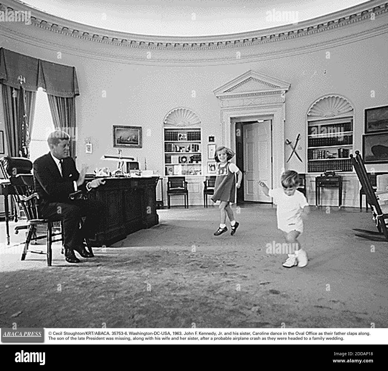 NO FILM, NO VIDEO, NO TV, NO DOCUMENTARY - © Cecil Stoughton/KRT/ABACA. 35753-6. Washington-DC-USA, 1963. John F. Kennedy, Jr. and his sister, Caroline dance in the Oval Office as their father claps along. The son of the late President was missing, along with his wife and her sister, after a proba Stock Photo