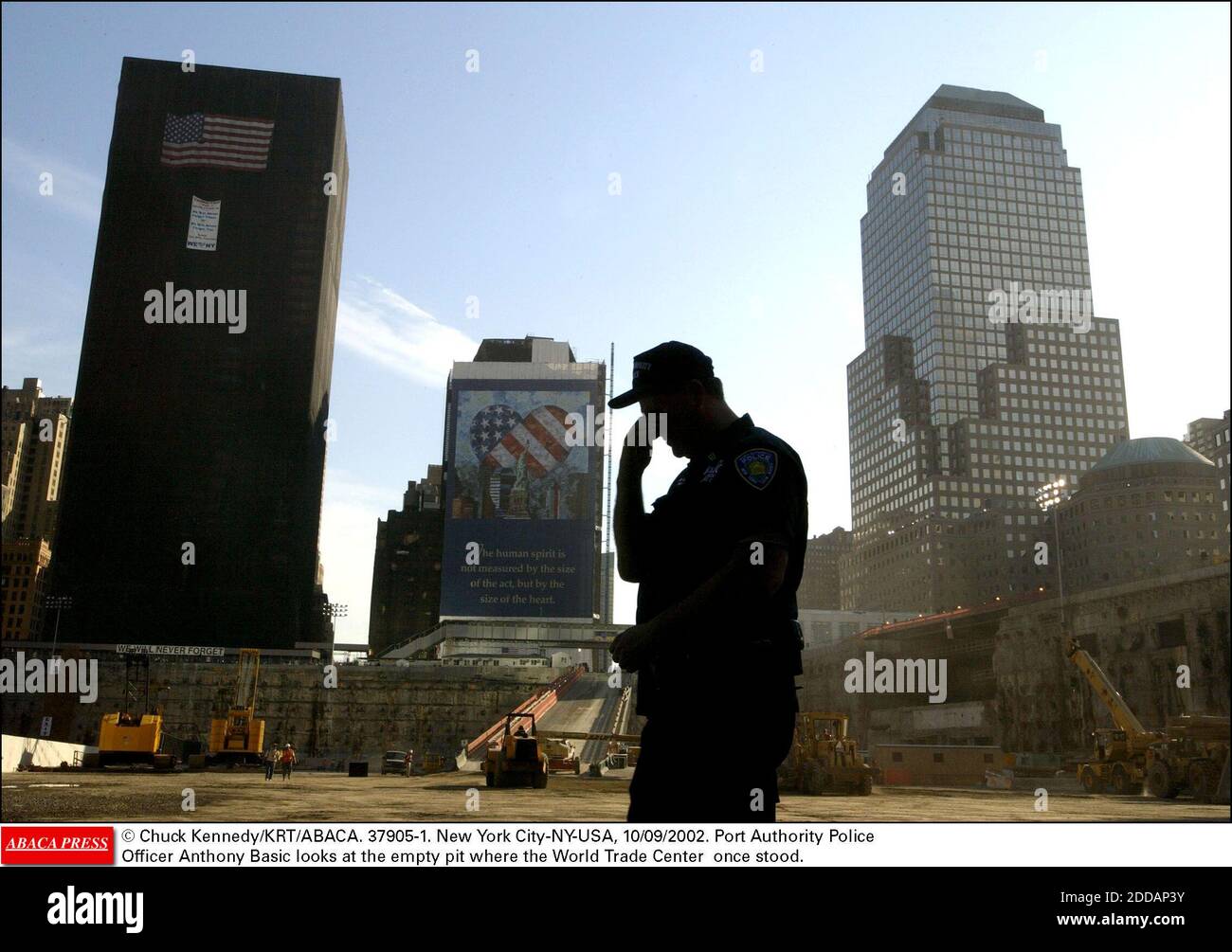 NO FILM, NO VIDEO, NO TV, NO DOCUMENTARY - © Chuck Kennedy/KRT/ABACA. 37905-1. New York City-NY-USA, 10/09/2002. Port Authority Police Officer Anthony Basic looks at the empty pit where the World Trade Center once stood. Stock Photo