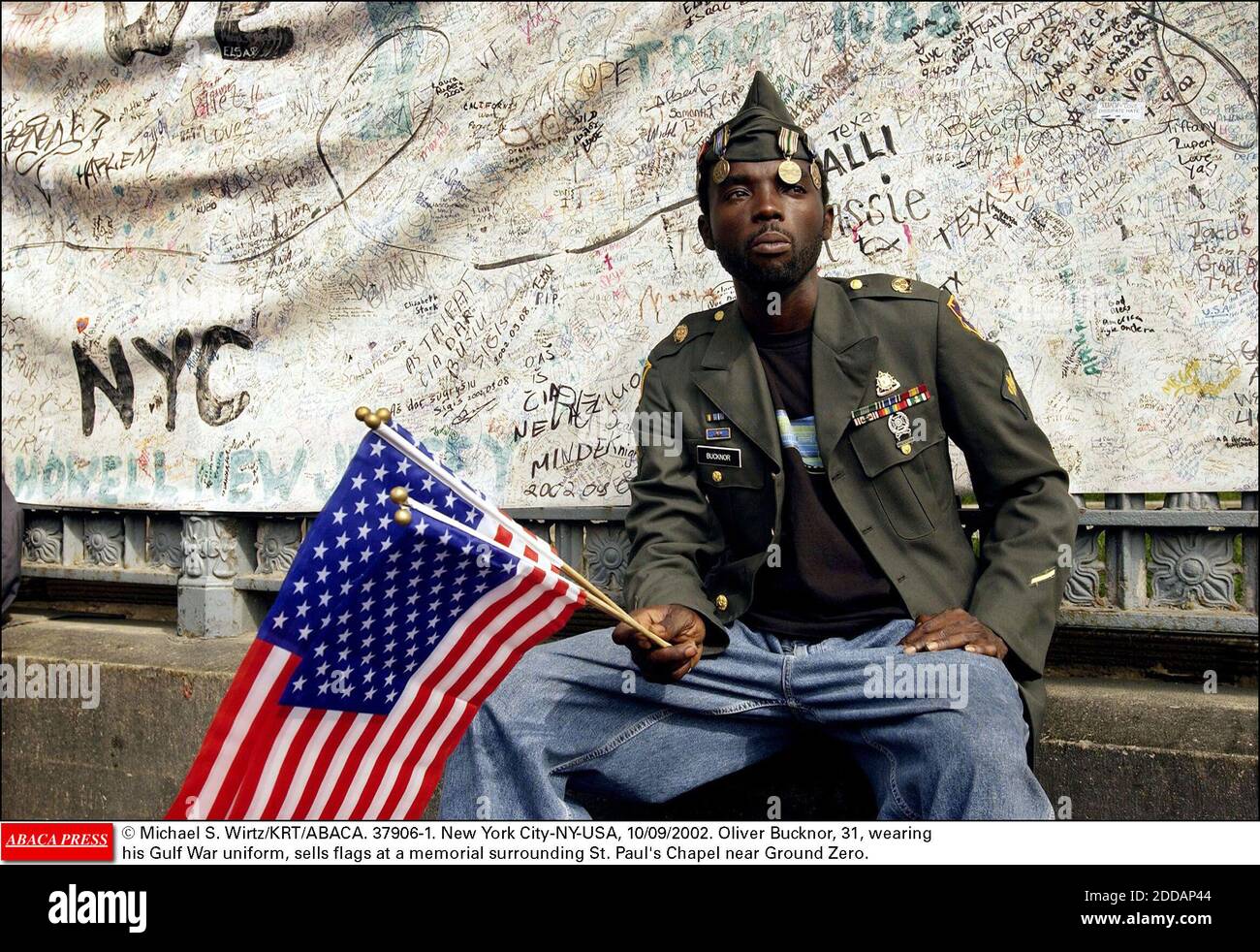 NO FILM, NO VIDEO, NO TV, NO DOCUMENTARY - © Michael S. Wirtz/KRT/ABACA. 37906-1. New York City-NY-USA, 10/09/2002. Oliver Bucknor, 31, wearing his Gulf War uniform, sells flags at a memorial surrounding St. Paul's Chapel near Ground Zero. Stock Photo