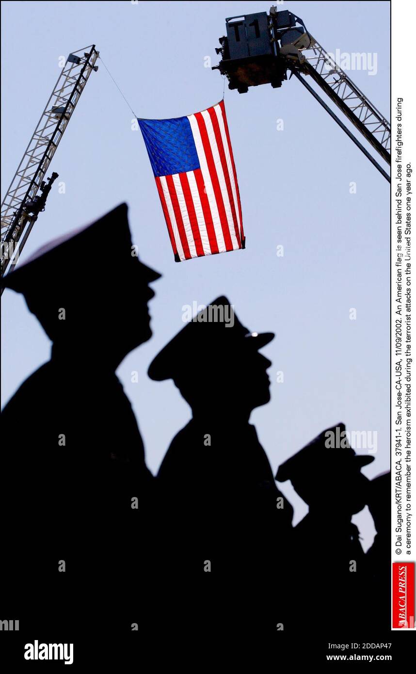 NO FILM, NO VIDEO, NO TV, NO DOCUMENTARY - © Dai Sugano/KRT/ABACA. 37941-1. San Jose-CA-USA, 11/09/2002. An American flag is seen behind San Jose firefighters duringa ceremony to remember the heroism exhibited during the terrorist attacks on the United States one year ago. Stock Photo