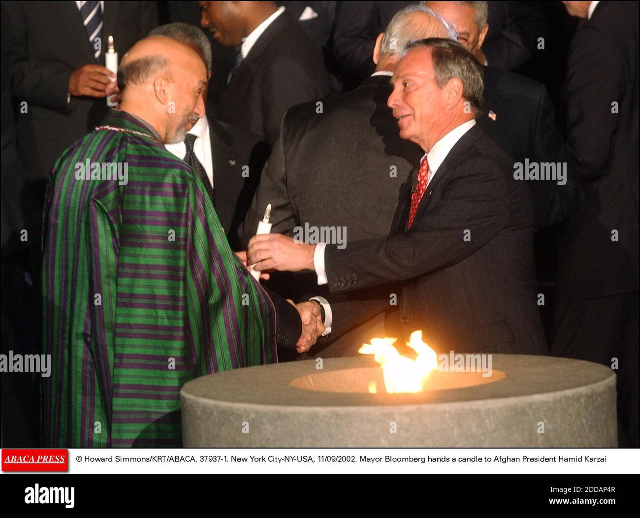NO FILM, NO VIDEO, NO TV, NO DOCUMENTARY - © Howard Simmons/KRT/ABACA. 37937-1. New York City-NY-USA, 11/09/2002. Mayor Bloomberg hands a candle to Afghan President Hamid Karzai Stock Photo