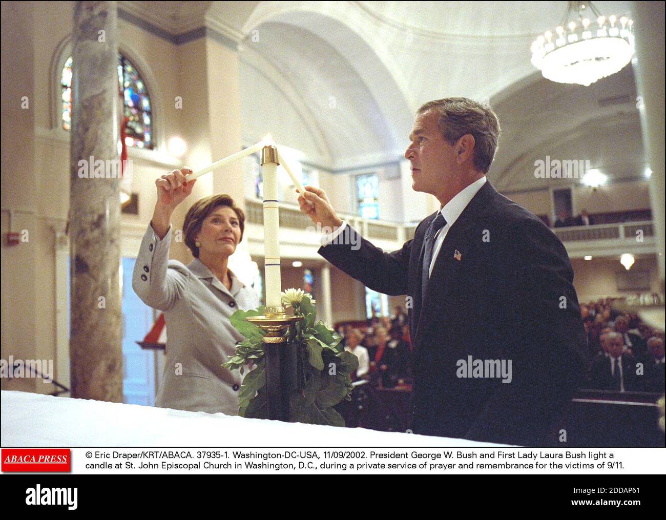 NO FILM, NO VIDEO, NO TV, NO DOCUMENTARY - © Eric Draper/KRT/ABACA. 37935-1. Washington-DC-USA, 11/09/2002. President George W. Bush and First Lady Laura Bush light a candle at St. John Episcopal Church in Washington, D.C., during a private service of prayer and remembrance for the victims of 9/11 Stock Photo