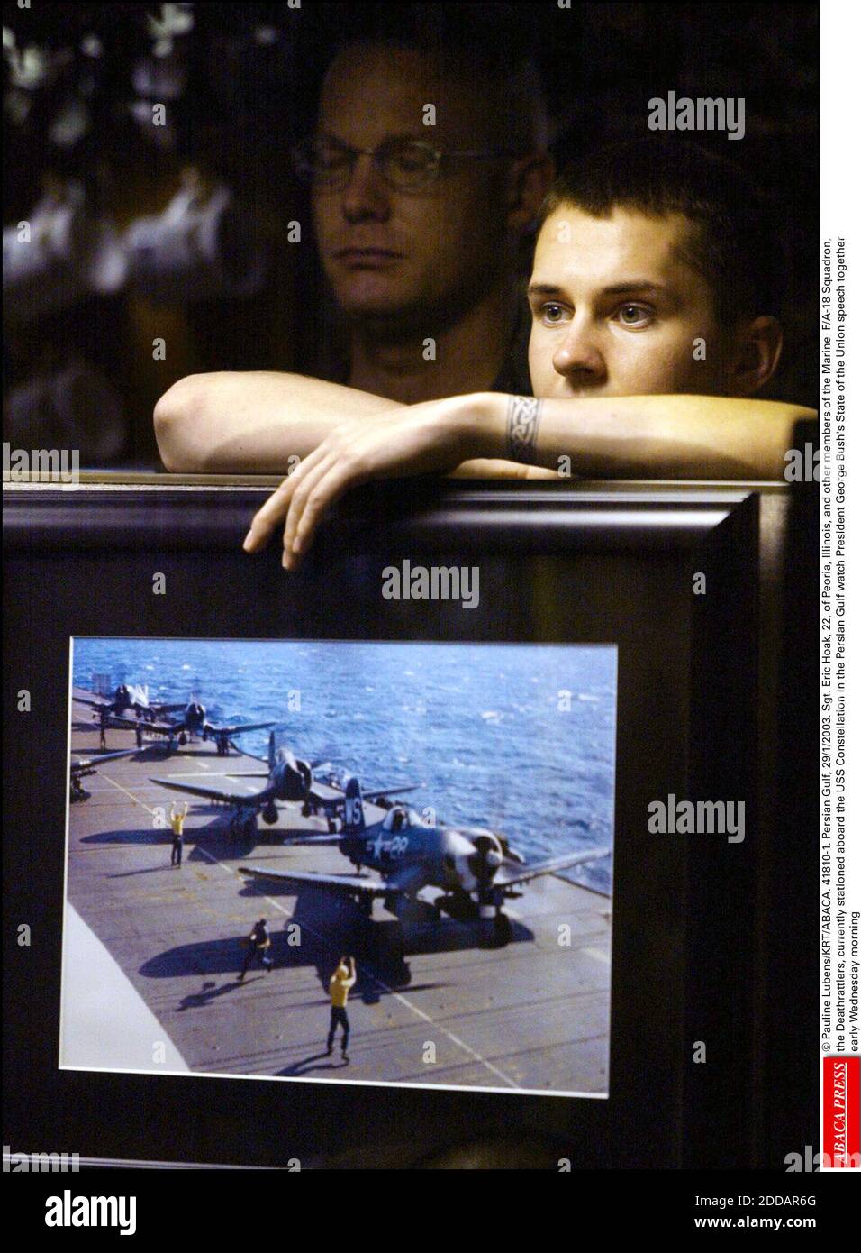 NO FILM, NO VIDEO, NO TV, NO DOCUMENTARY - © Pauline Lubens/KRT/ABACA. 41810-1. Persian Gulf, 29/1/2003. Sgt. Eric Hoak, 22, of Peoria, Illinois, and other members of the Marine F/A-18 Squadron, the Deathrattlers, currently stationed aboard the USS Constellation in the Persian Gulf watch President Stock Photo