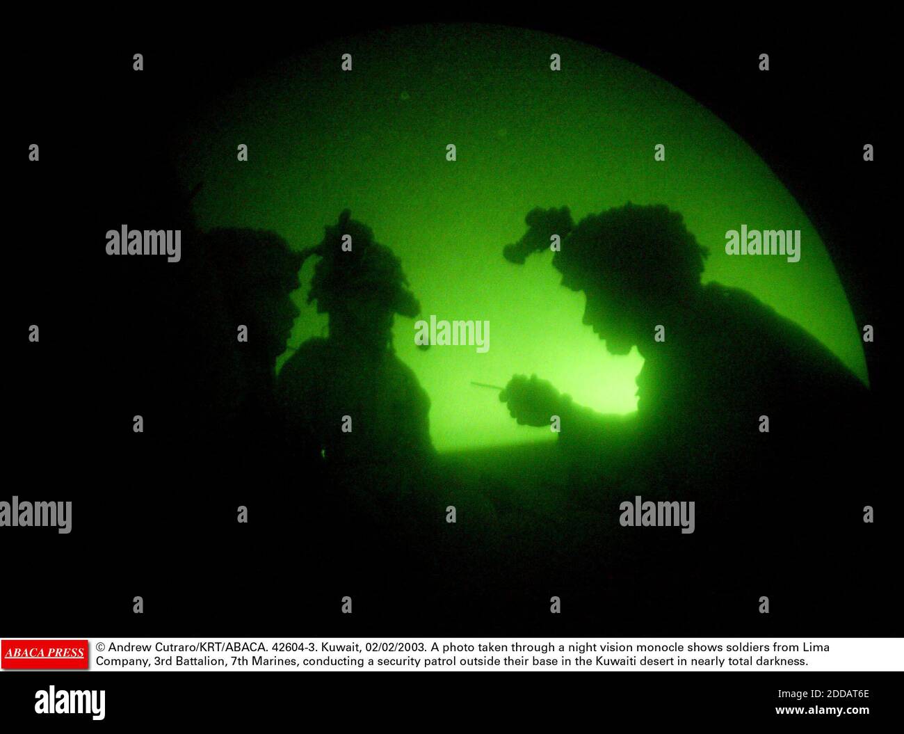 NO FILM, NO VIDEO, NO TV, NO DOCUMENTARY - © Andrew Cutraro/KRT/ABACA. 42604-3. Kuwait, 02/02/2003. A photo taken through a night vision monocle shows soldiers from Lima Company, 3rd Battalion, 7th Marines, conducting a security patrol outside their base in the Kuwaiti desert in nearly total darkn Stock Photo