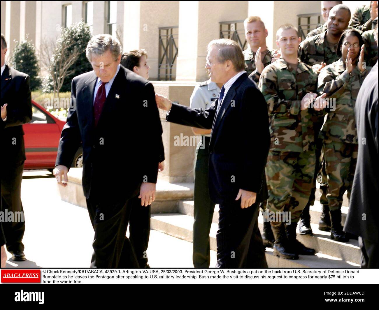 NO FILM, NO VIDEO, NO TV, NO DOCUMENTARY - © Chuck Kennedy/KRT/ABACA. 43929-1. Arlington-VA-USA, 25/03/2003. President George W. Bush gets a pat on the back from U.S. Secretary of Defense Donald Rumsfeld as he leaves the Pentagon after speaking to U.S. military leadership. Bush made the visit to d Stock Photo