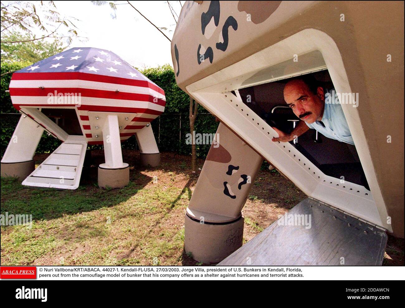 NO FILM, NO VIDEO, NO TV, NO DOCUMENTARY - © Nuri Vallbona/KRT/ABACA. 44027-1. Kendall-FL-USA. 27/03/2003. Jorge Villa, president of U.S. Bunkers in Kendall, Florida, peers out from the camouflage model of bunker that his company offers as a shelter against hurricanes and terrorist attacks. Stock Photo