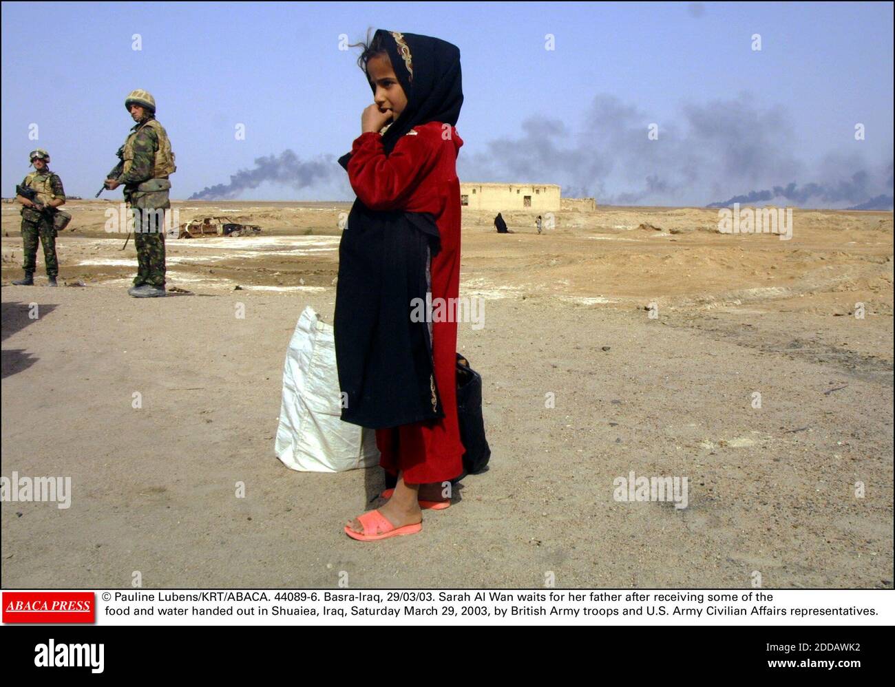 NO FILM, NO VIDEO, NO TV, NO DOCUMENTARY - © Pauline Lubens/KRT/ABACA. 44089-6. Basra-Iraq, 29/03/03. Sarah Al Wan waits for her father after receiving some of the food and water handed out in Shuaiea, Iraq, Saturday March 29, 2003, by British Army troops and U.S. Army Civilian Affairs representat Stock Photo