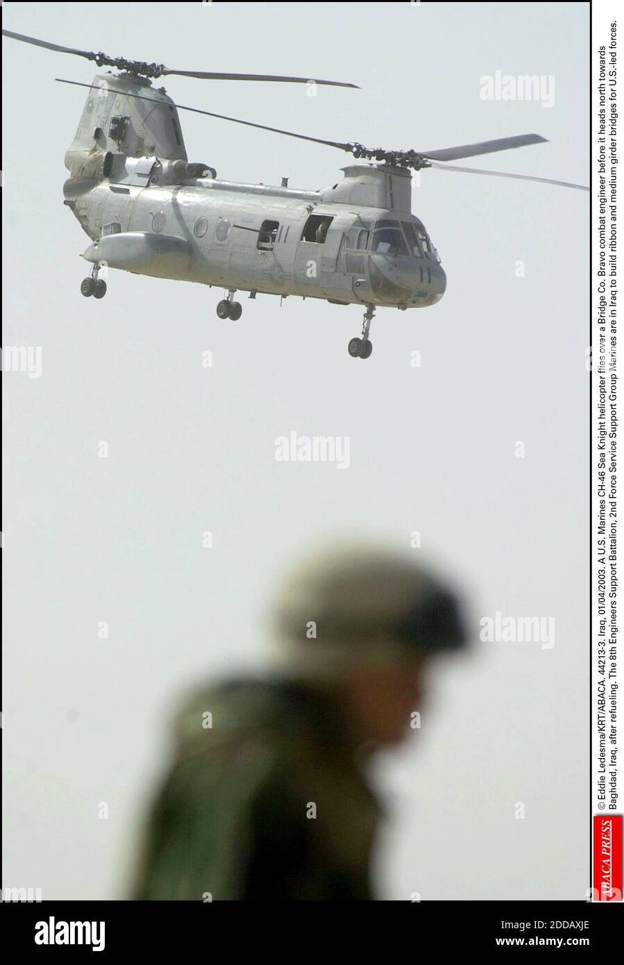 NO FILM, NO VIDEO, NO TV, NO DOCUMENTARY - © Eddie Ledesma/KRT/ABACA. 44213-3. Iraq, 01/04/2003. A U.S. Marines CH-46 Sea Knight helicopter flies over a Bridge Co. Bravo combat engineer before it heads north towards Baghdad, Iraq, after refueling. The 8th Engineers Support Battalion, 2nd Force Ser Stock Photo