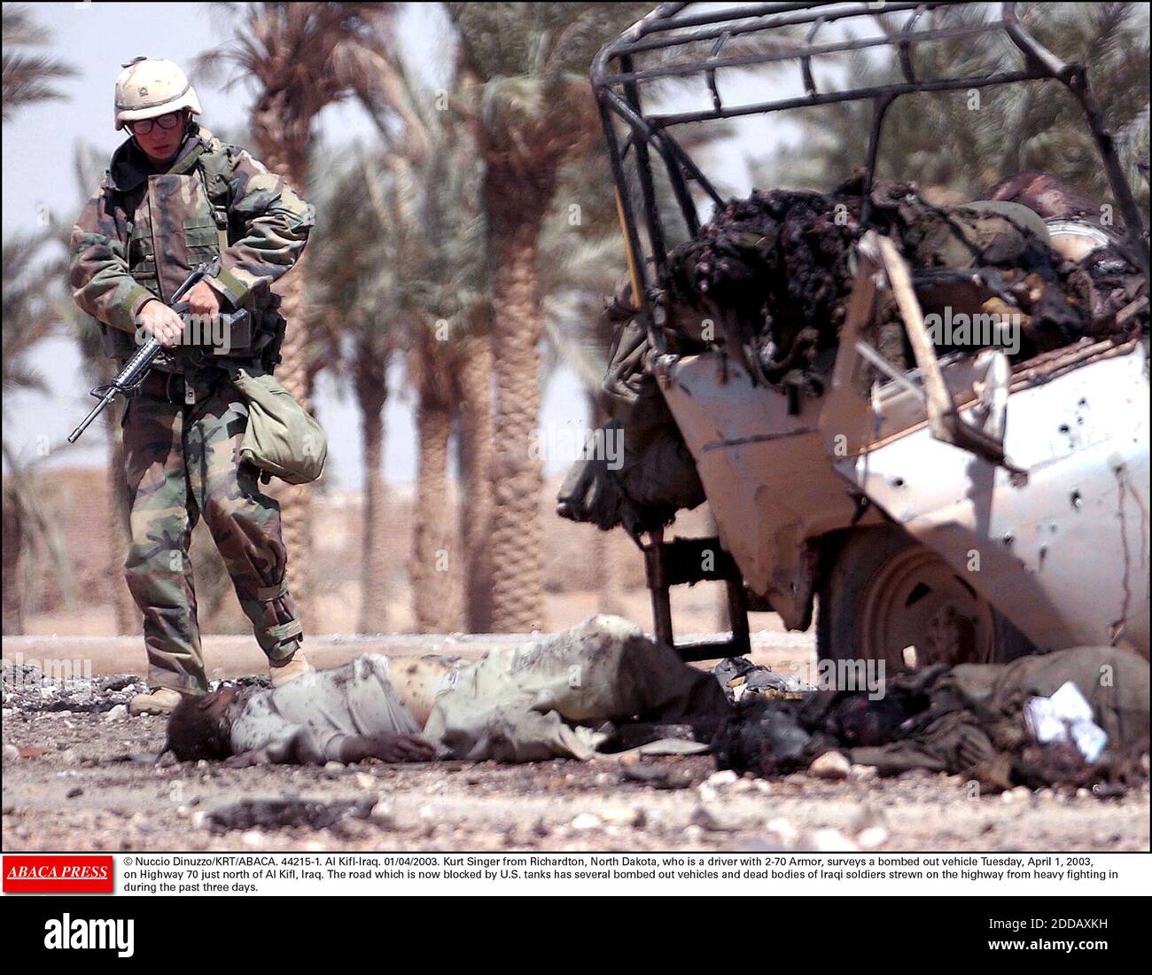 NO FILM, NO VIDEO, NO TV, NO DOCUMENTARY - © Nuccio Dinuzzo/KRT/ABACA. 44215-1. Al Kifl-Iraq. 01/04/2003. Kurt Singer from Richardton, North Dakota, who is a driver with 2-70 Armor, surveys a bombed out vehicle Tuesday, April 1, 2003, on Highway 70 just north of Al Kifl, Iraq. The road which is no Stock Photo