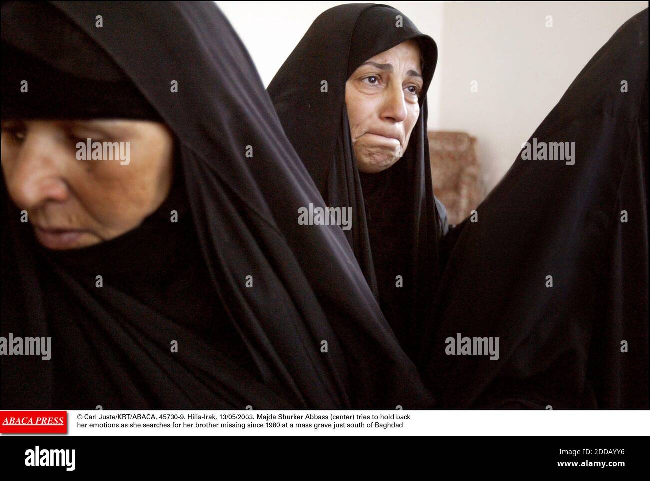 NO FILM, NO VIDEO, NO TV, NO DOCUMENTARY - © Carl Juste/KRT/ABACA. 45730-9. Hilla-Irak, 13/05/2003. Majda Shurker Abbass (center) tries to hold back her emotions as she searches for her brother missing since 1980 at a mass grave just south of Baghdad Stock Photo