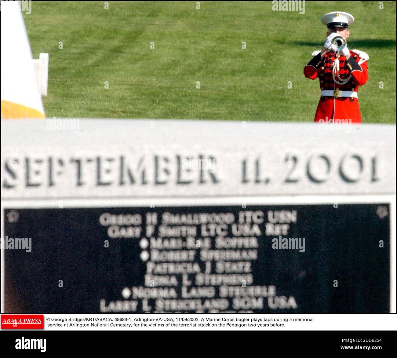NO FILM, NO VIDEO, NO TV, NO DOCUMENTARY - © George Bridges/KRT/ABACA. 49684-1. Arlington-VA-USA, 11/09/2003. A Marine Corps bugler plays taps during a memorial service at Arlington National Cemetery, for the victims of the terrorist attack on the Pentagon two years before. Stock Photo