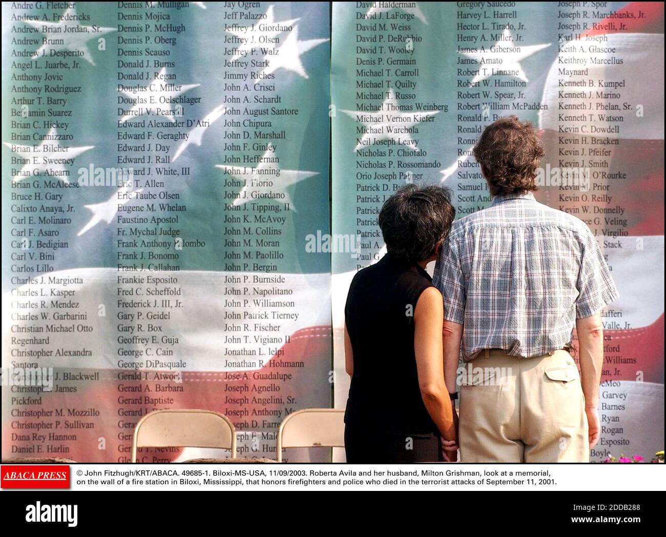 NO FILM, NO VIDEO, NO TV, NO DOCUMENTARY - © John Fitzhugh/KRT/ABACA. 49685-1. Biloxi-MS-USA, 11/09/2003. Roberta Avila and her husband, Milton Grishman, look at a memorial, on the wall of a fire station in Biloxi, Mississippi, that honors firefighters and police who died in the terrorist attacks Stock Photo