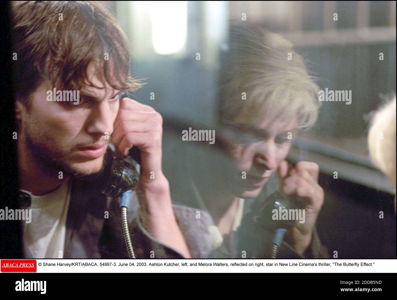 NO FILM, NO VIDEO, NO TV, NO DOCUMENTARY - © Shane Harvey/KRT/ABACA. 54997-3. June 04, 2003. Ashton Kutcher, left, and Melora Walters, reflected on right, star in New Line Cinema's thriller, The Butterfly Effect. Stock Photo