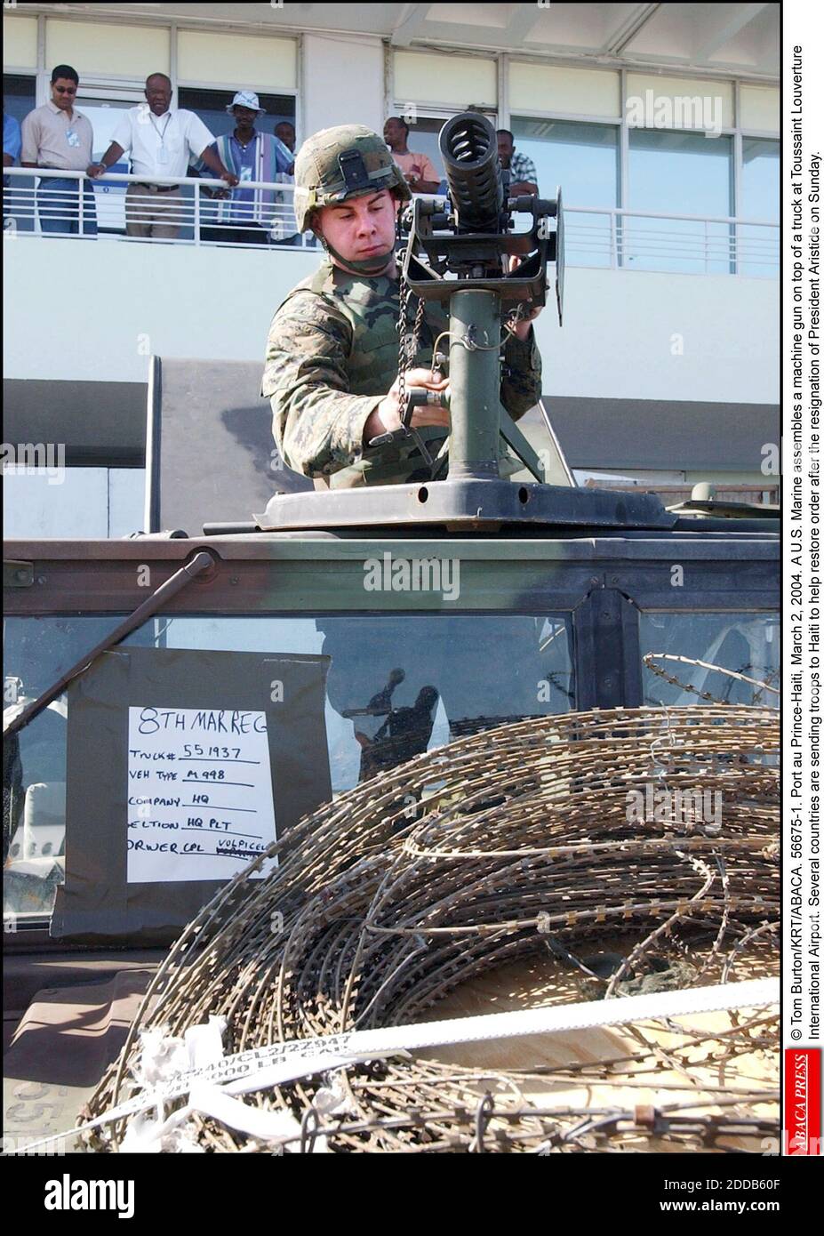 NO FILM, NO VIDEO, NO TV, NO DOCUMENTARY - © Tom Burton/KRT/ABACA. 56675-1. Port au Prince-Haiti, March 2, 2004. A U.S. Marine assembles a machine gun on top of a truck at Toussaint Louverture International Airport. Several countries are sending troops to Haiti to help restore order after the resi Stock Photo