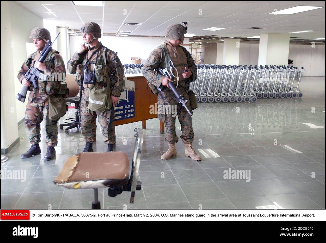 NO FILM, NO VIDEO, NO TV, NO DOCUMENTARY - © Tom Burton/KRT/ABACA. 56675-2. Port au Prince-Haiti, March 2, 2004. U.S. Marines stand guard in the arrival area at Toussaint Louverture International Airport in Port-Au-Prince, Haiti, on Tuesday, March 2, 2004. (mvw) 2004 Stock Photo