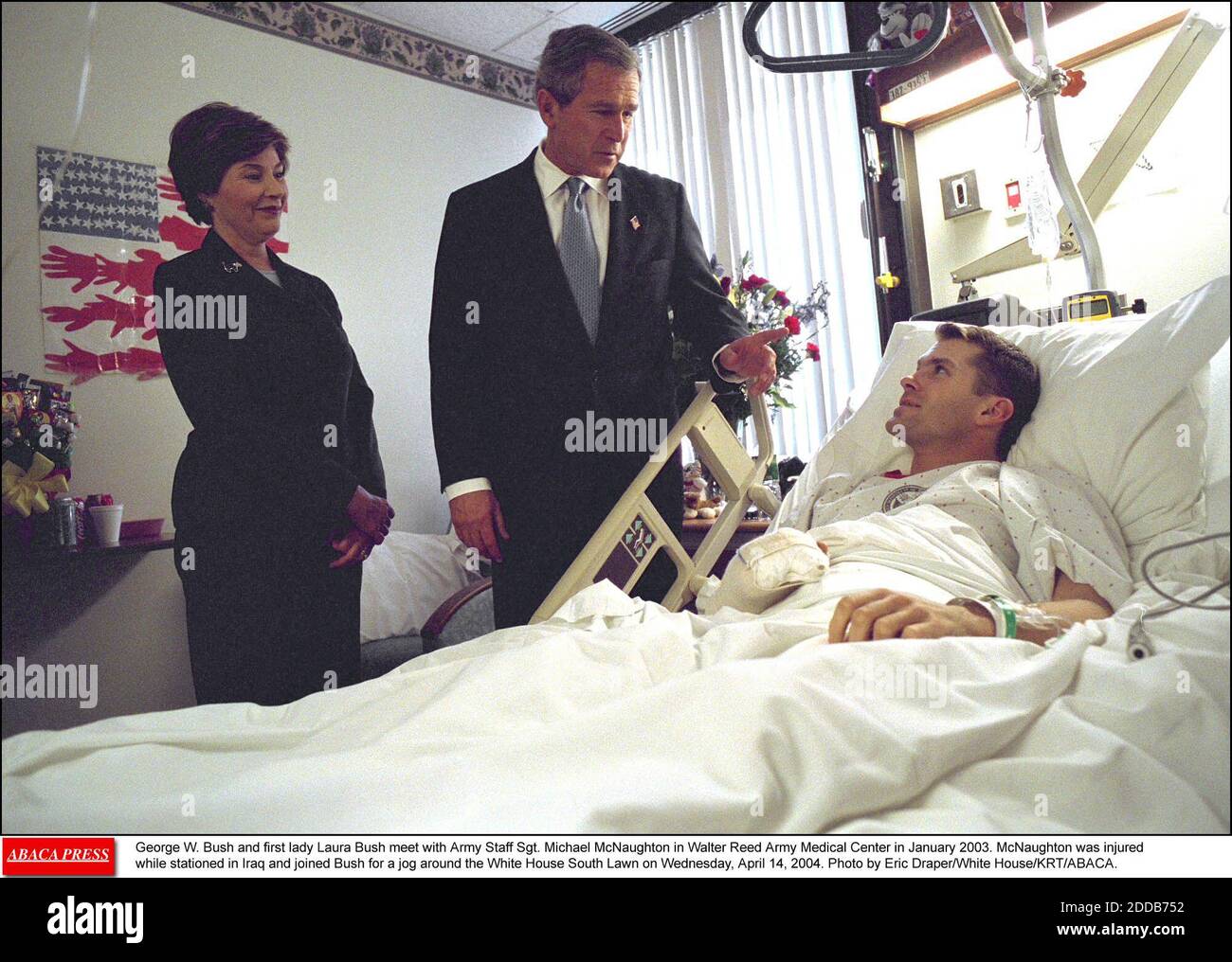 NO FILM, NO VIDEO, NO TV, NO DOCUMENTARY - George W. Bush and first lady Laura Bush meet with Army Staff Sgt. Michael McNaughton in Walter Reed Army Medical Center in January 2003. McNaughton was injured while stationed in Iraq and joined Bush for a jog around the White House South Lawn on Wednesday, April 14, 2004. Photo by Eric Draper/White House/KRT/ABACA. Stock Photo