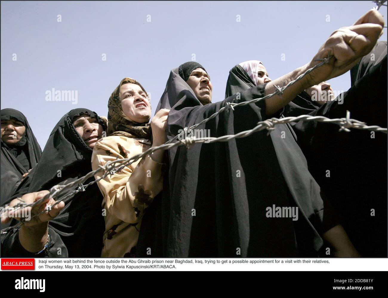 NO FILM, NO VIDEO, NO TV, NO DOCUMENTARY - Iraqi women wait behind the fence outside the Abu Ghraib prison near Baghdad, Iraq, trying to get a possible appointment for a visit with their relatives, on Thursday, May 13, 2004. Photo by Sylwia Kapuscinski/KRT/ABACA. Stock Photo