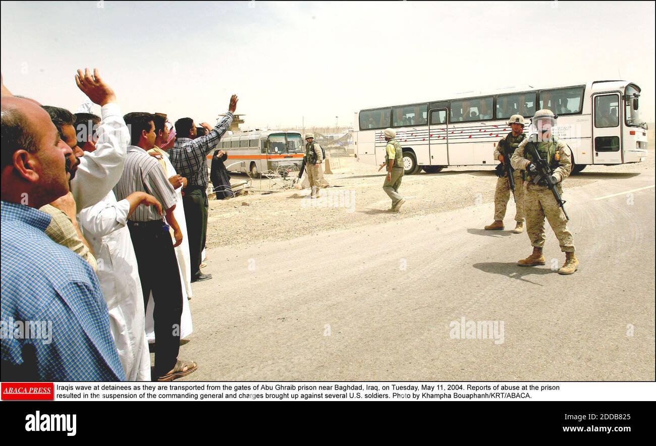 NO FILM, NO VIDEO, NO TV, NO DOCUMENTARY - Iraqis wave at detainees as they are transported from the gates of Abu Ghraib prison near Baghdad, Iraq, on Tuesday, May 11, 2004. Reports of abuse at the prison resulted in the suspension of the commanding general and charges brought up against several U.S. soldiers. Photo by Khampha Bouaphanh/KRT/ABACA. Stock Photo