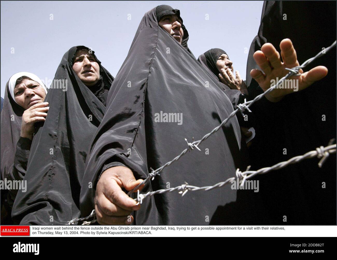 NO FILM, NO VIDEO, NO TV, NO DOCUMENTARY - Iraqi women wait behind the fence outside the Abu Ghraib prison near Baghdad, Iraq, trying to get a possible appointment for a visit with their relatives, on Thursday, May 13, 2004. Photo by Sylwia Kapuscinski/KRT/ABACA. Stock Photo