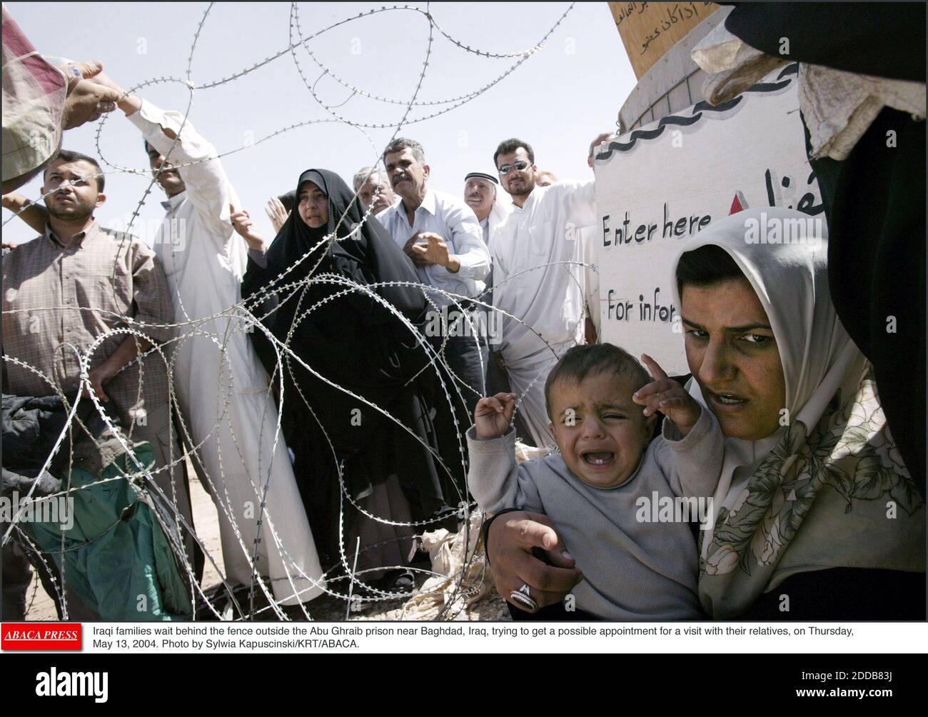 NO FILM, NO VIDEO, NO TV, NO DOCUMENTARY - Iraqi families wait behind the fence outside the Abu Ghraib prison near Baghdad, Iraq, trying to get a possible appointment for a visit with their relatives, on Thursday, May 13, 2004. Photo by Sylwia Kapuscinski/KRT/ABACA. Stock Photo