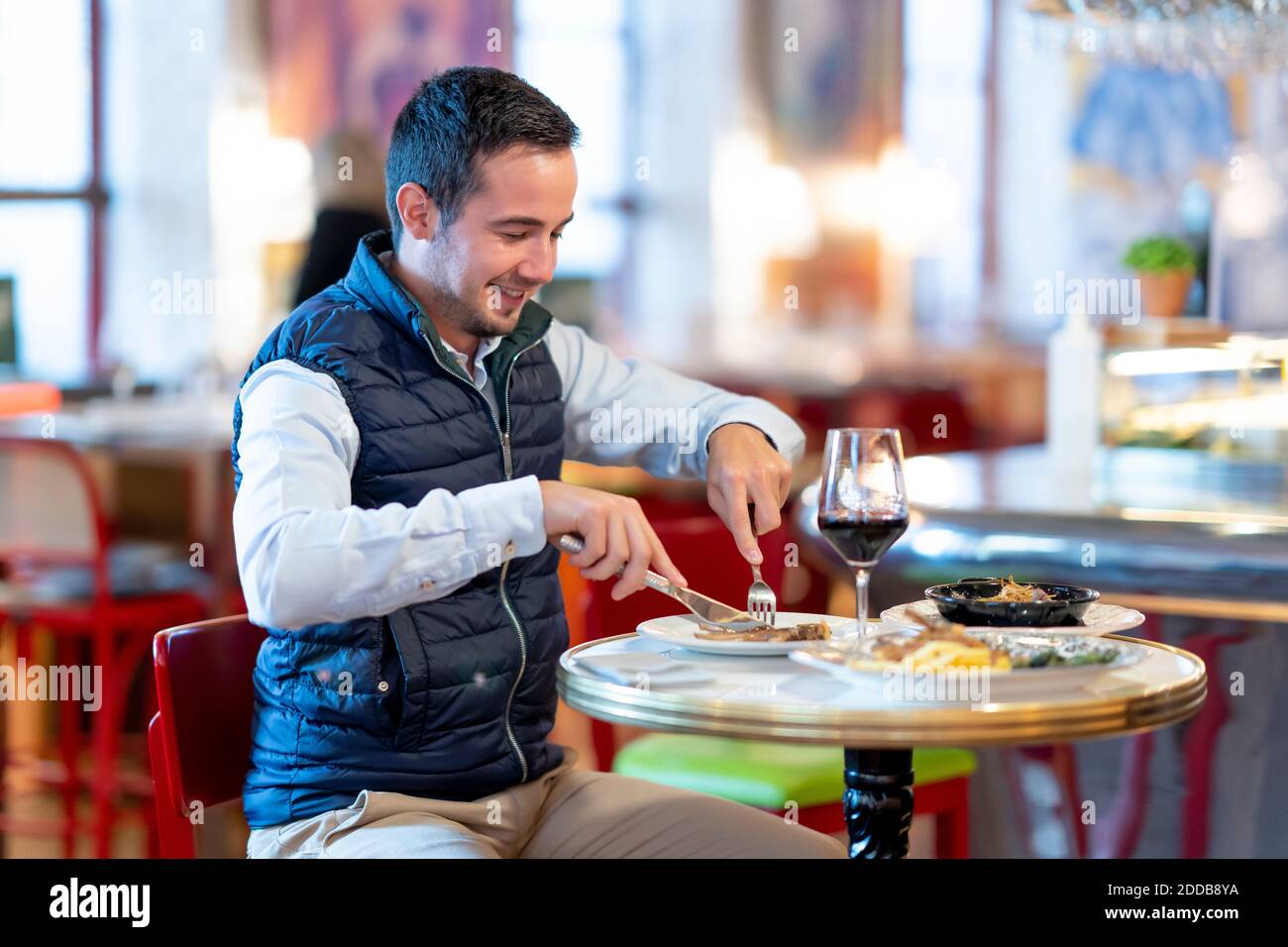 Young man having lunch while sitting in restaurant Stock Photo