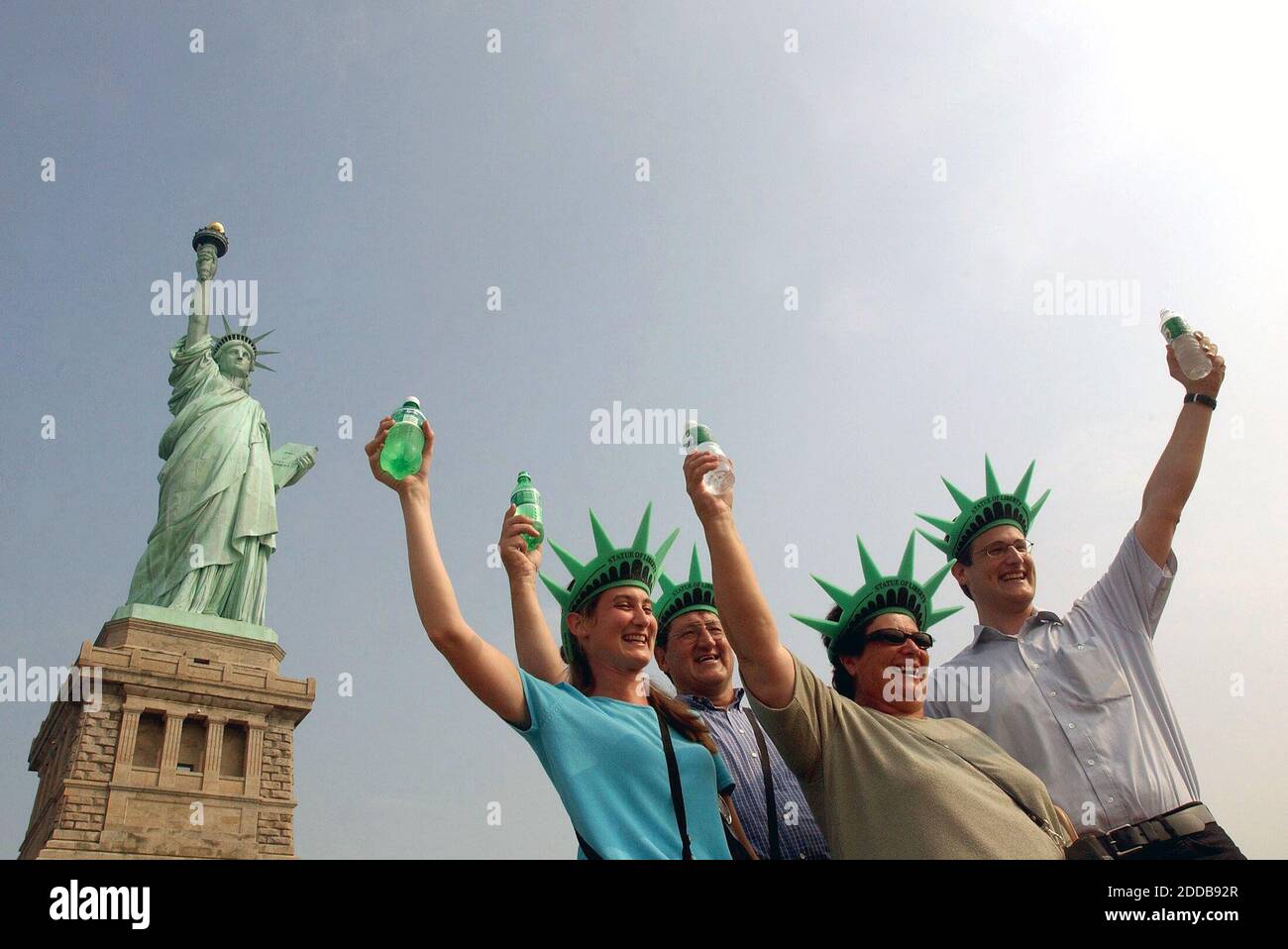 NO FILM, NO VIDEO, NO TV, NO DOCUMENTARY - The Tannast family from  Switzerland pose in front of the Statue of Liberty as it opens to tourists  for the first time on