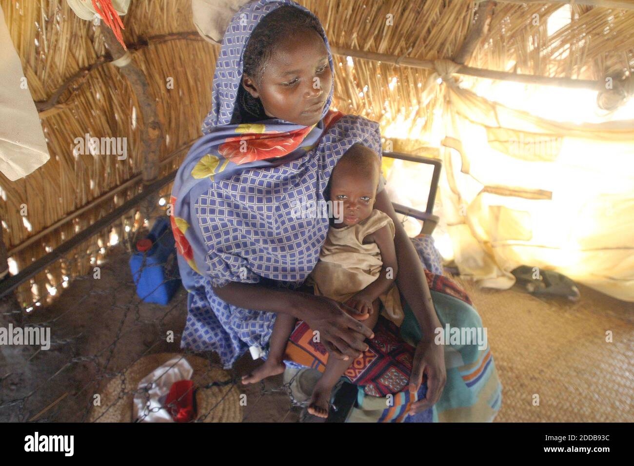 NO FILM, NO VIDEO, NO TV, NO DOCUMENTARY - Kaltoma Musa holds her son Anas at a the Kalma refugee camp in the Darfur region of Sudan on July 17, 2004. Anas' twin sister, Enas Abbakr, died the night before from severe malnourishment. Photo by Evelyn Hockstein/KRT/ABACA. Stock Photo