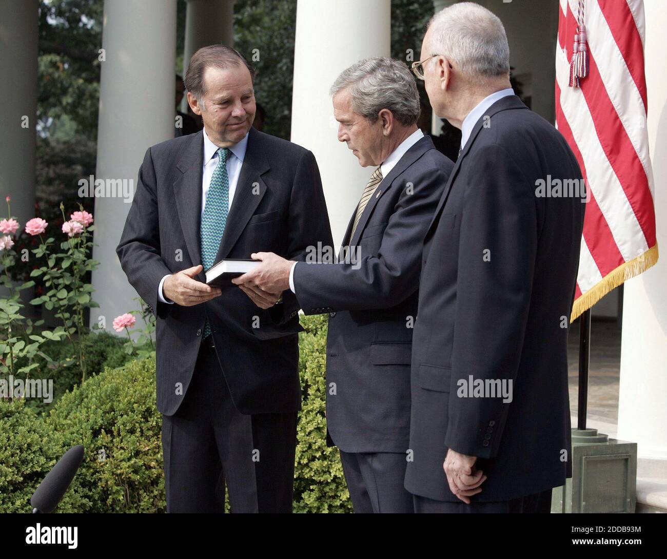 NO FILM, NO VIDEO, NO TV, NO DOCUMENTARY - President George W. Bush receives the 9/11 Commission final report from 9/11 Commission Chairman Thomas H. Kean (l) and Vice Chairman Lee H. Hamilton in the Rose Garden of the White House in Washington, D.C., on July 22, 2004. The commission's report detailed 'deep institutional failings' and missed opportunities by both the Bush and Clinton administrations to thwart the terrorist hijackings on September 11, 2001. Photo by Chuck Kennedy/KRT/ABACA Stock Photo
