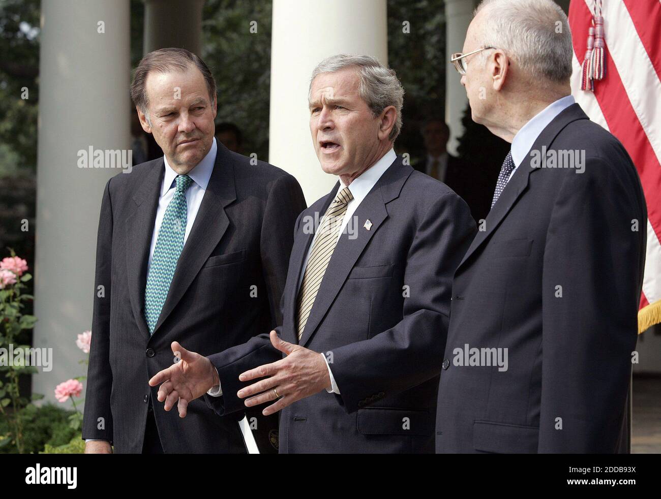 NO FILM, NO VIDEO, NO TV, NO DOCUMENTARY - President George W. Bush receives the 9/11 Commission final report from 9/11 Commission Chairman Thomas H. Kean (l) and Vice Chairman Lee H. Hamilton in the Rose Garden of the White House in Washington, D.C., on July 22, 2004. The commission's report detailed 'deep institutional failings' and missed opportunities by both the Bush and Clinton administrations to thwart the terrorist hijackings on September 11, 2001. Photo by Chuck Kennedy/KRT/ABACA. Stock Photo