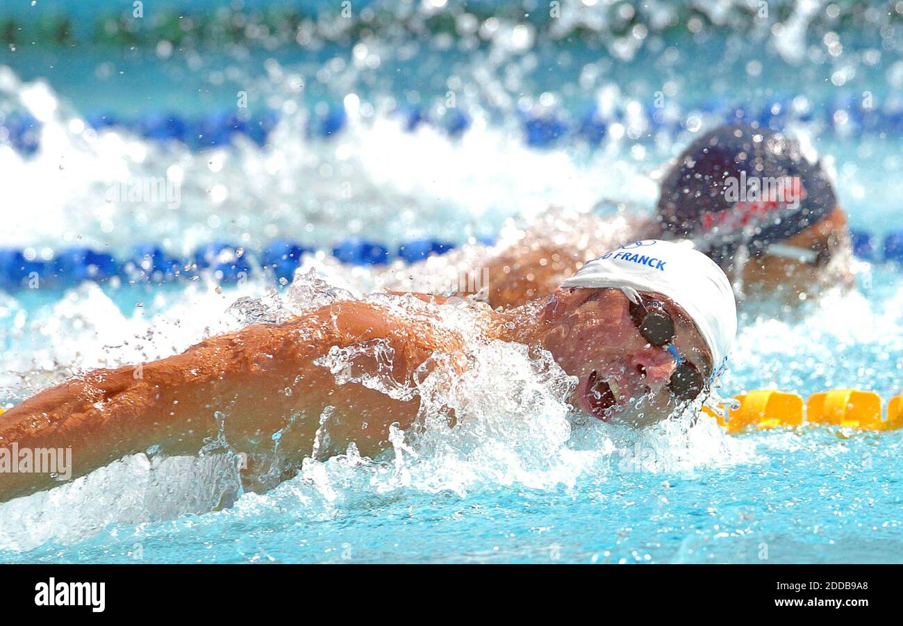 NO FILM, NO VIDEO, NO TV, NO DOCUMENTARY - Takashi Yamamoto, top moves by France's Franck Esposito in a 200-meter butterfly qualifying heat on Monday, August 16, 2004, during the Olympic Games in Athens, Greece. Photo by Karl Mondon/KRT/ABACA. Stock Photo