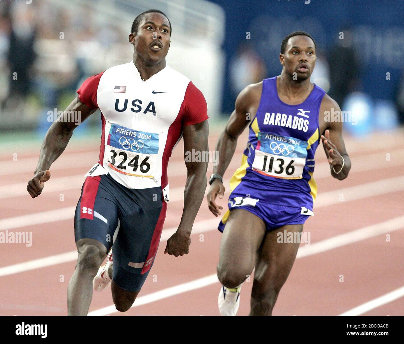NO FILM, NO VIDEO, NO TV, NO DOCUMENTARY - Shawn Crawford of the United States, left, and Obadele Thompson of Barbados look for their times after a heat of the 100 meters at the 2004 Olympic Games on Saturday, August 21, 2004. Photo by Nhat V. Meyer/San Jose Mercury News/KRT/ABACA Stock Photo
