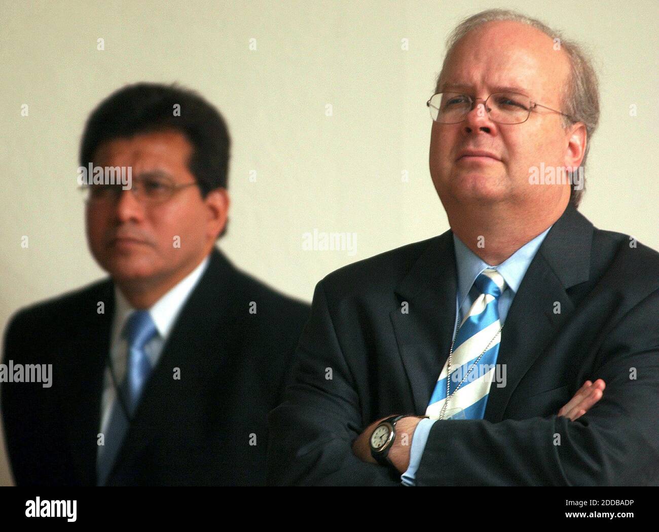 NO FILM, NO VIDEO, NO TV, NO DOCUMENTARY - Karl Rove, a top White House advisor, right, and White House Counsel Albert Gonzales listen as President George W. Bush addresses the war in Iraq as well as the economy during a news conference in the Rose Garden at the White House on Wednesday, July 30, 2003. Photo by George Bridges/KRT/ABACA Stock Photo