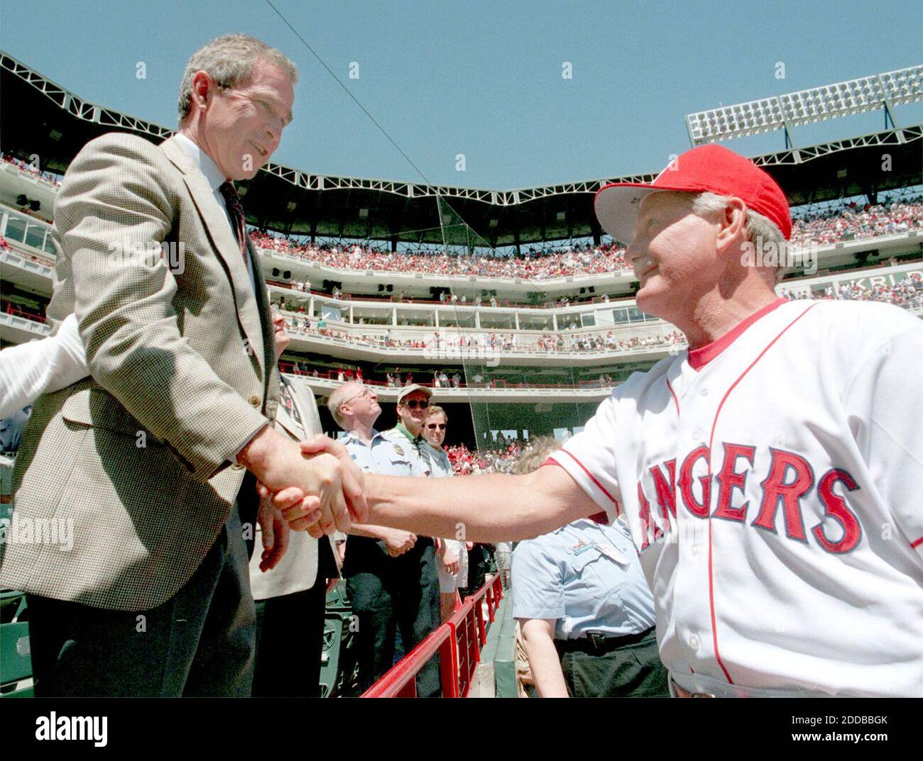 NO FILM, NO VIDEO, NO TV, NO DOCUMENTARY - Governor George W. Bush and Manager Johnny Oates shake hands before the opening day game. Texas Rangers vs. Detroit Tigers, opening game for the 1999 season at The Ballpark in Arlington on April 5, 1999. Photo by Rick Moon/Fort Worth Star-Telegram/KRT/ABACA. Stock Photo