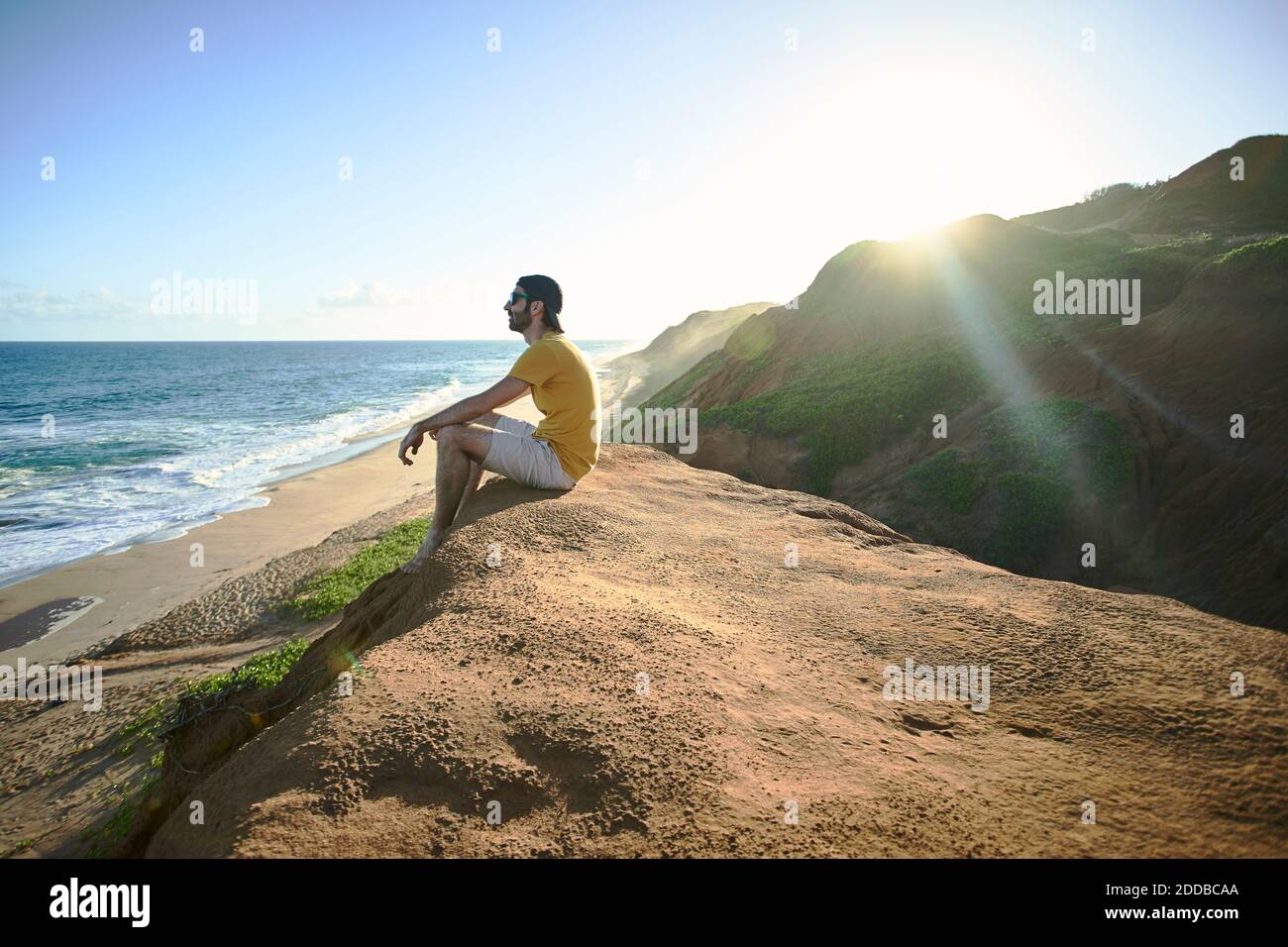 Man sitting on rock looking hi-res stock photography and images - Alamy