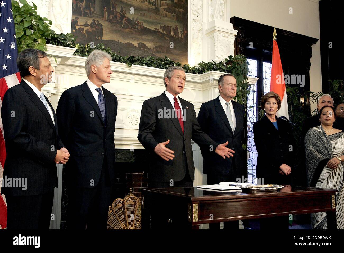 NO FILM, NO VIDEO, NO TV, NO DOCUMENTARY - U.S. President George W. Bush , first lady Laura Bush (2nd r) and former Presidents Bill Clinton (l) and George H. W. Bush (r) visit the Indian embassy in Washington, January 3, 2005. Bush brought together former presidents George Bush and Clinton on Monday to launch an appeal for Americans to make a donation to help victims of the South Asia quake and tsunamis. The president's father and Clinton will lead a bipartisan effort to seek out donations both large and small to provide relief assistance to millions left homeless by the Dec. 26 calamity that Stock Photo