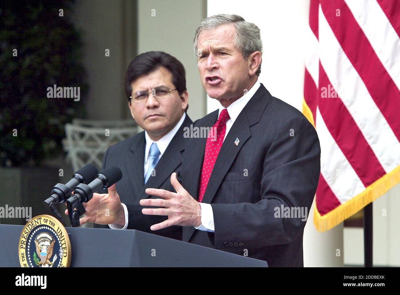 NO FILM, NO VIDEO, NO TV, NO DOCUMENTARY - U.S. President George W. Bush makes remarks on Judicial Independence and the Judicial Confirmation Process as White House Counsel Alberto Gonzales looks on from the Rose Garden at The White House in Washington, D.C. on Friday, May 9, 2003. President Bush has chosen White House counsel Alberto Gonzales, a Texas confidant and the most prominent Hispanic in the administration, to succeed Attorney General John Ashcroft. November 10, 2004. Photo by Chuck Kennedy/KRT/ABACA. Stock Photo