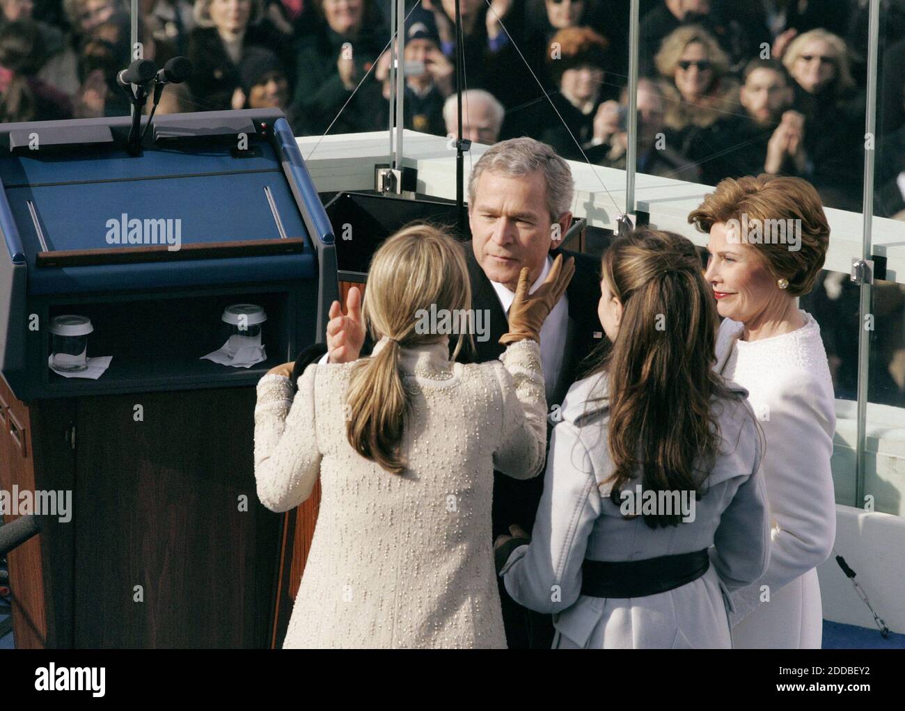 NO FILM, NO VIDEO, NO TV, NO DOCUMENTARY - U.S. President George W. Bush kisses his daughter Jenna, left, during Inauguration ceremonies on Capitol Hill in Washington, January 20, 2005, as First Lady Laura Bush, right looks on with daughter Barbara, second from left. Washington, DC, USA, on January 20, 2005. Photo by Chuck Kennedy/US News Story Slugged/KRT/ABACA. Stock Photo